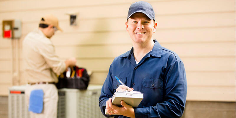 Techs working on commercial HVAC unit